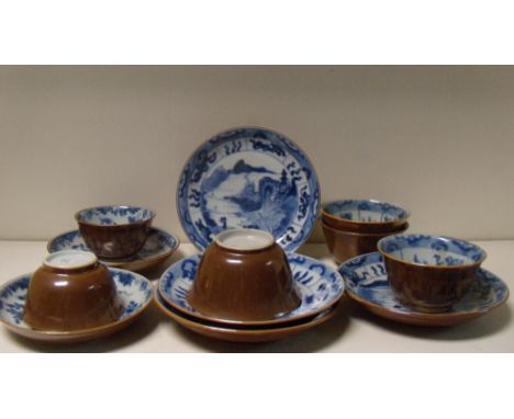 Four and a pair of 18th century Batavian tea bowls and saucers, each with brown exteriors, the four with blue island views ce