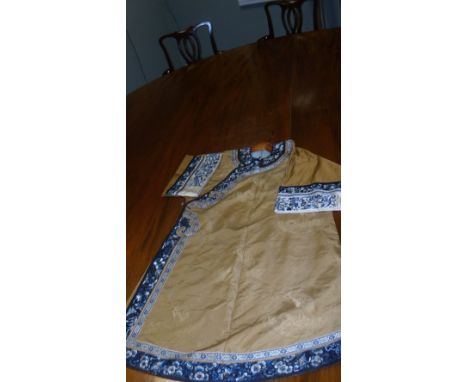 A 19th century brown silk brocade three quarter length robe, woven with crane roundels, the side closure, collar, hems and cu