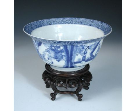 A blue and white bowl, six character mark and period of Kangxi, with hardwood stand, the flared rim with bands of diamond dia