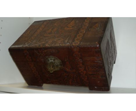 An early 20th century zhang mu (camphor) wood box, the hinged rectangular lid and sides carved in low relief with boats saili