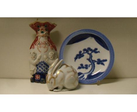 An Arita blue and white plate, a Kutani rabbit and and Imari wall pocket, the plate painted with a pine tree before Mount Fuj