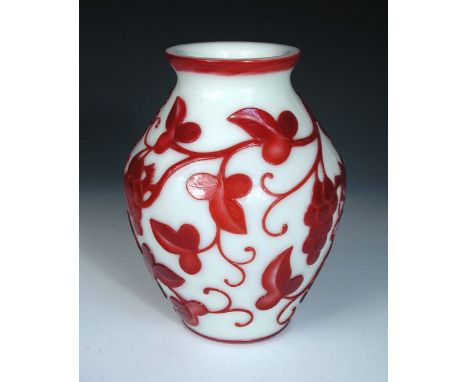 A ruby overlay white glass vase. the ovoid body trailed with grapes on their vines between red lined rims, 24cm (9.5 in) high