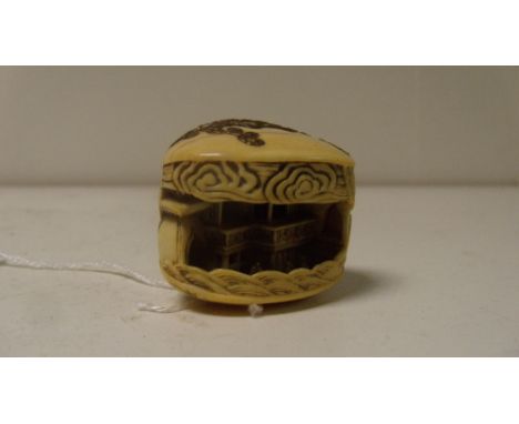 Mitsunobu, a 19th century ivory netsuke depicting the clam's dream, the shells of the mollusc gold lacquered with seaweed scr