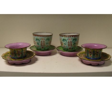 Two pairs of 19th century Canton enamel bowls and stands, the larger pair with iron red shou characters alternating with flow