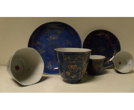 Two pairs of 18th century powder blue ground tea bowls and two saucers, each tea bowl with a red cherry blossom central to th
