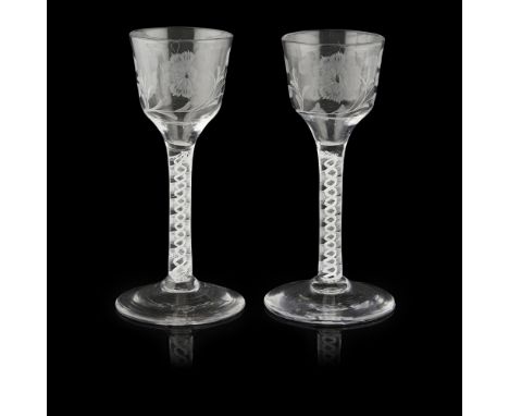 OF JACOBITE INTEREST, A PAIR OF ENAMEL-TWIST STEM WINE GLASSES  with ogee bowls, engraved with rose heads/carnations and foli