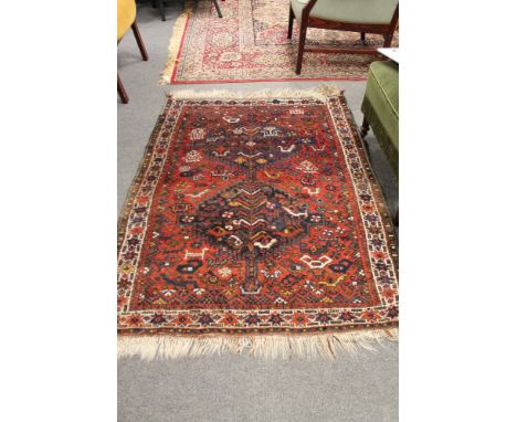 A fringed Persian carpet 