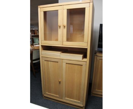 A light oak double door glazed cabinet 