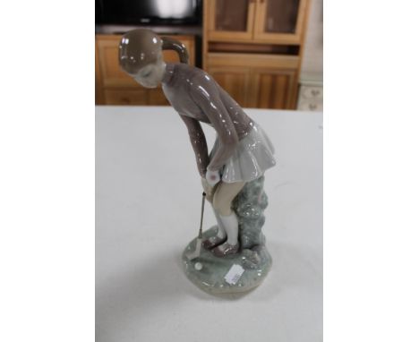 A Nao figure of a female golfer 