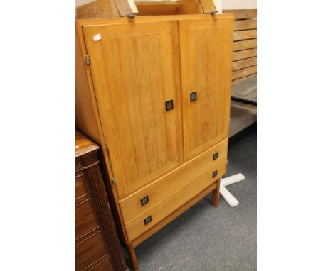 A double door light oak cabinet fitted with two drawers 