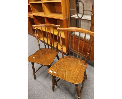 A pair of stick back beech armchairs 