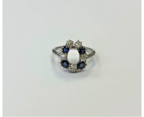 An antique 18ct sapphire and diamond horseshoe style ring