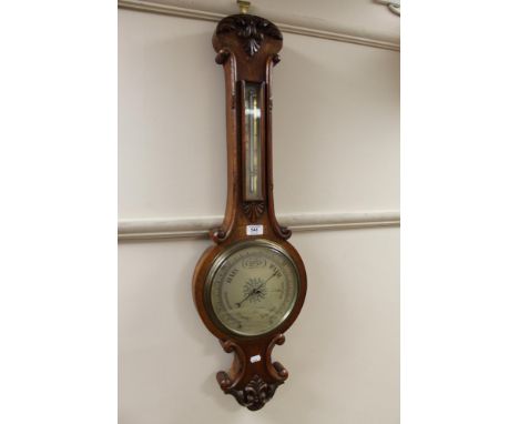An early twentieth century carved oak barometer 