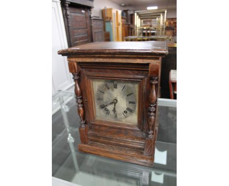 A continental oak cased bracket clock with silvered dial 