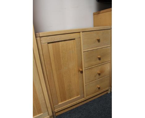 A light oak storage cabinet fitted with four drawers 