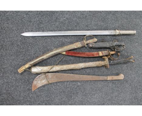 A vintage machete and other bladed weapons, a short sword etc