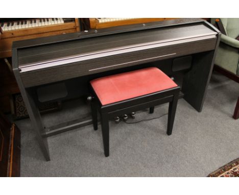 An electric keyboard with stool and a ladder 