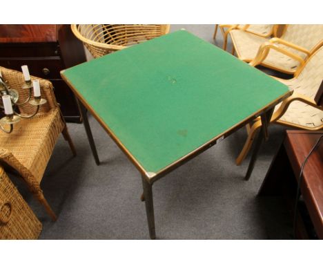 A folding card table together with a wicker chair and a linen basket 
