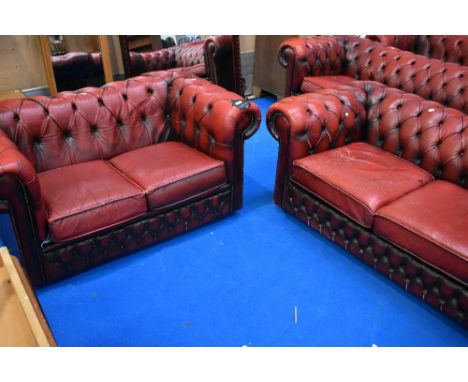 Two red leather button back Chesterfield two seater settees