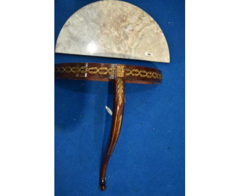 A small traditional demi lune wall console with marble top