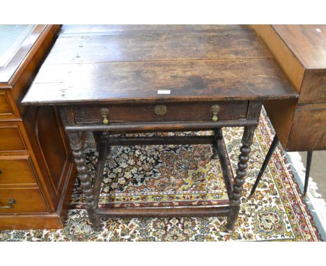 A Jacobean oak side table with single drawer, bobbin turned legs, with a all round base stretcher, 86cm wide