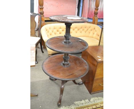 A 19th Century mahogany three tiered dumb waiter of typical form raised on a tripod base, 110cm high