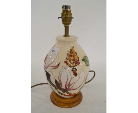 A Moorcroft table lamp, the white ground with a tubelined floral design