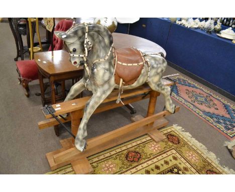 A 20th Century dappled grey painted rocking horse on hardwood and iron frame, apparently unsigned, 132cm wide max