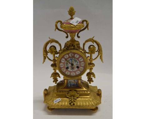 A late Victorian gilt brass mantel clock with porcelain dial, painted in Sevres style with flowers and cornucopia