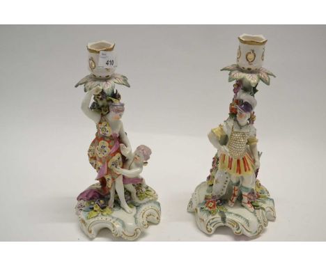 A pair of 18th Century Derby candlestick figures of a Roman soldier and a lady with cherub (both sconces restored), 27cm high