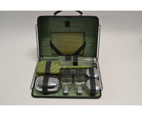 A vanity case with various bottles and hair brush