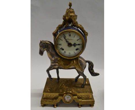 A Victorian gilt brass mantel clock, the clock mounted on a white metal horse, the dial with Roman numerals marked Imperial, 