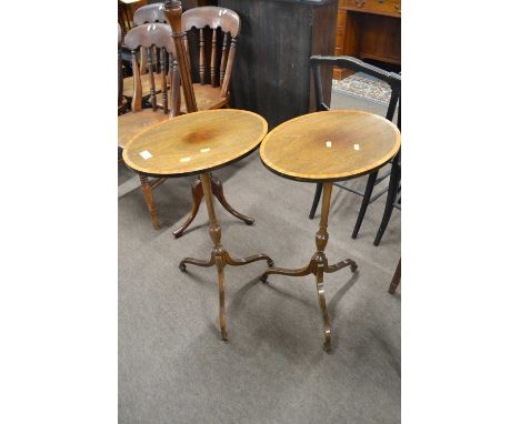 A pair of mahogany and cross banded wine tables with oval tops, turned stems and tripod bases, 74cm high