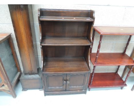 A mid to late 20th Century oak bookcase with double cupboard under in the Ercol style