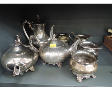 Two silver plated tea sets having engraved decoration and bracket feet
