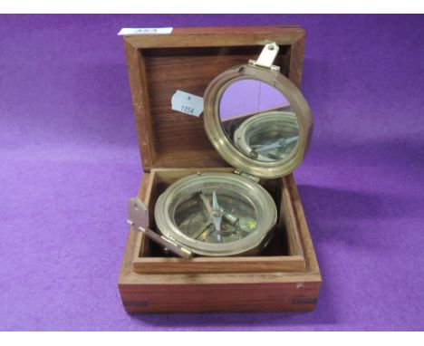 A boxed brass compass