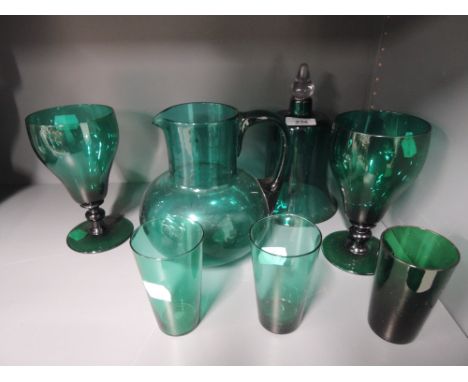 A selection of jade green glass wares including jug, bell and glasses