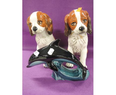 A selection of vintage ceramic figurines including large Poole dolphin and spaniel pair