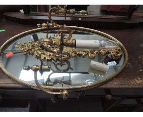 A reproduction brass side lit mirror and a gilt effect sconce wall light