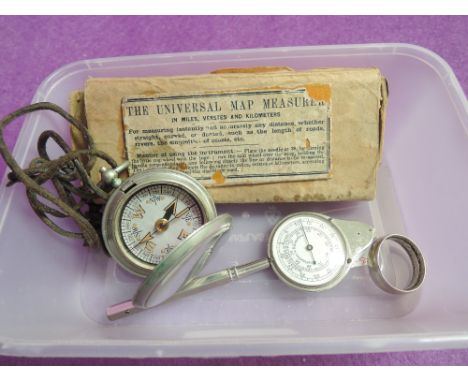 A vintage boxed Universal map measurer, band ring made from a 1942 half crown coin and base metal compass