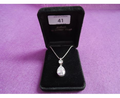 A cubic zirconia double drop pendant in a silver mount on silver chain