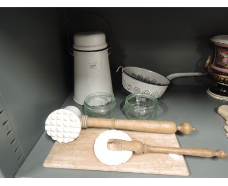 A selection of vintage kitchen items including enamel pot and strainer
