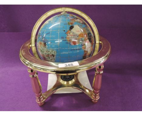 A Lapis Globe, inlayed with semi precious gemstones on brass stand with centralised compass 
