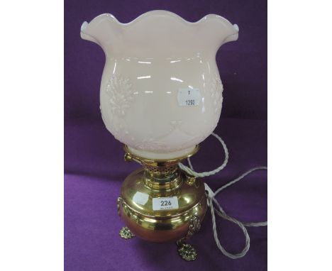 A vintage brass converted oil burning lamp with whit and pink pressed shade