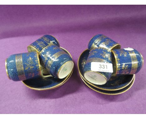 A set of six Copeland Spode coffee cups and saucers, having gilt heightened blue ground