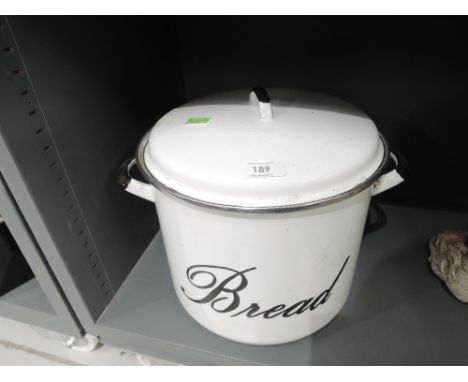 A vintage enamel circular bread bin