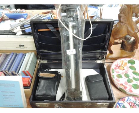 A Canon Sureshot camera, a Fuji 250ix zoom, a tripod in a hard document case