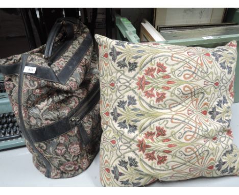 A vintage carpet bag and cushion