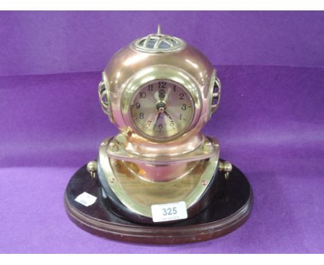 A vintage style brass and copper cast model replica of a divers helmet with clock as face