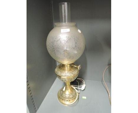 A vintage converted oil buring lamp with etched glass shade 
